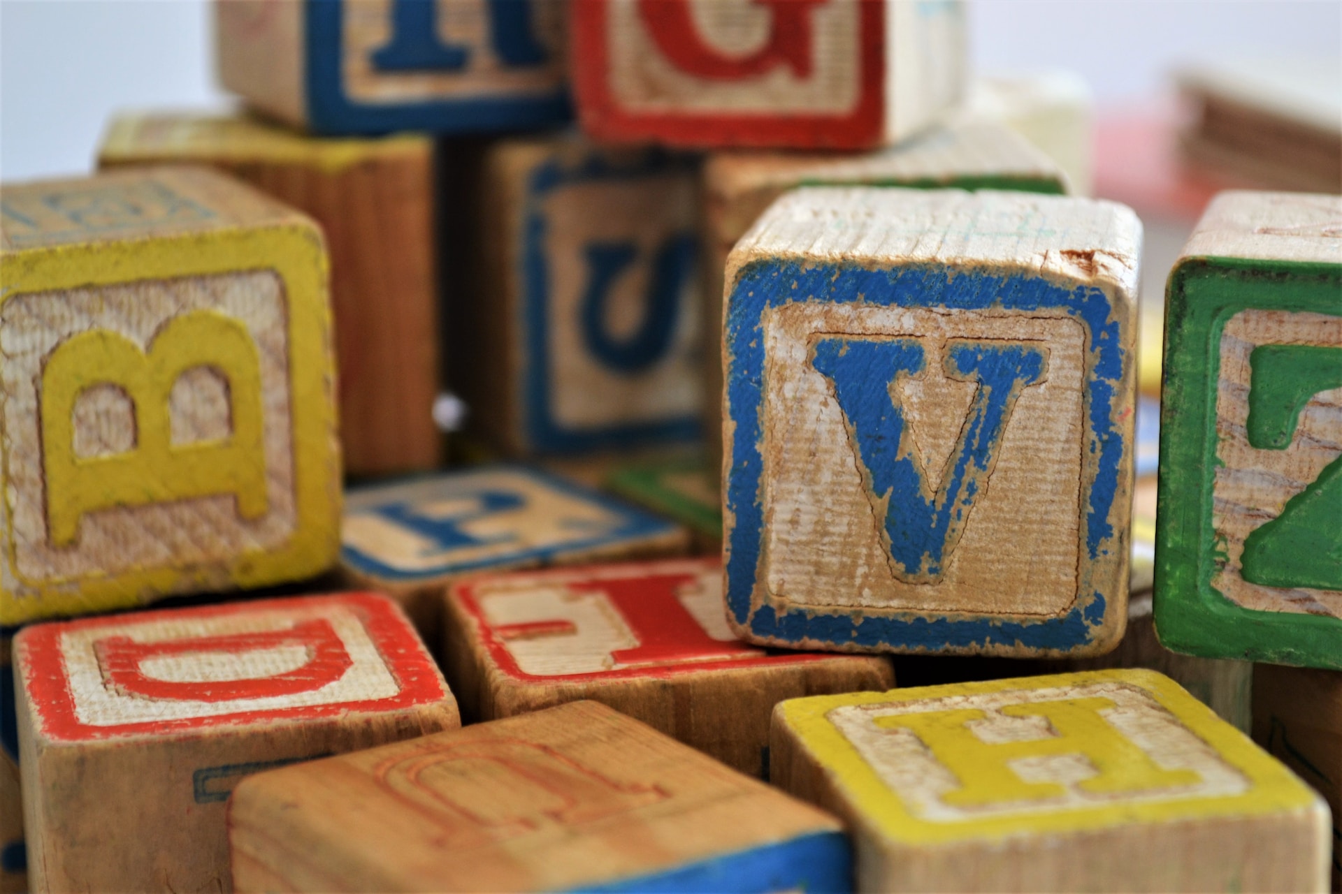 colored, wooden toy blocks stacked randomly